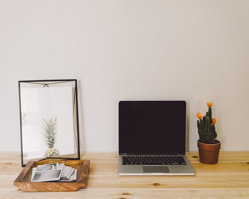 Person stretching arms gently at a home office setup